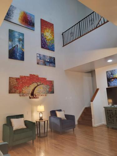 a living room with paintings on the wall at Reservoir Hill Mansion - 4 bedrooms in Baltimore