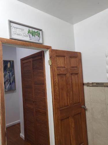 a room with a wooden door and a sign on the wall at Reservoir Hill Mansion - 4 bedrooms in Baltimore