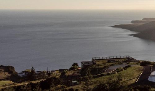a view of the ocean from the top of a hill at Villa - Cantinho do Paraíso in Santo Espírito