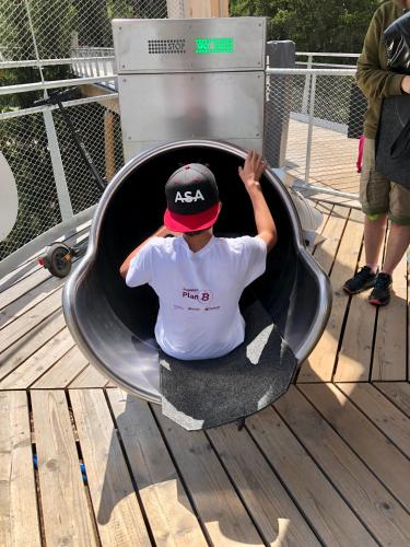 a young man sitting in a wheelbarrow at Rancho Laaxdeluxe in Laax