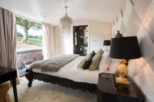 a bedroom with a bed and a large window at Who'd A Thought It in Lenham