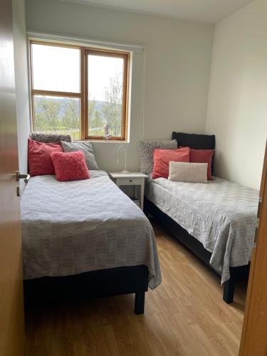 a bedroom with two beds and a window at Halakot guesthouse in Laugardælir