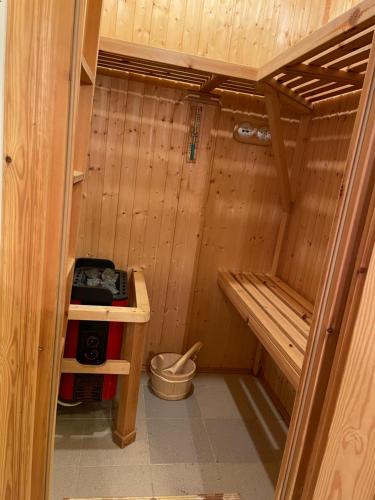 a small wooden cabin with a toilet in it at Halakot guesthouse in Laugardælir