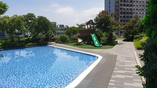 a swimming pool with a slide and a playground at Heart of Makati, Fully furnished condo, cbd central location in Manila
