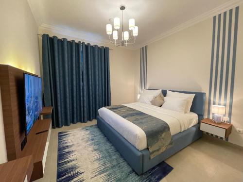 Кровать или кровати в номере GOODWOOD SUITES HOMES VACATION