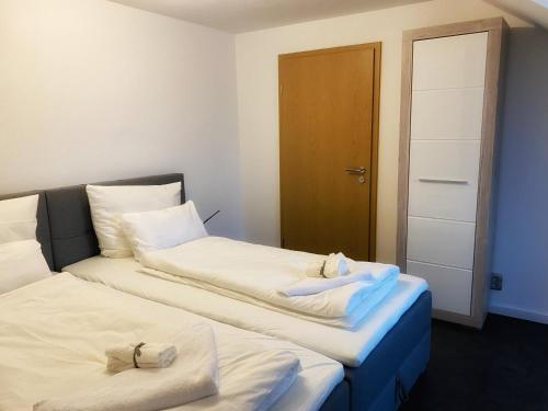 two beds sitting next to each other in a room at Cozy Apartment Bernburg 3 in Roschwitz