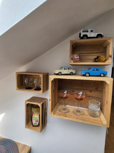 a shelf with two wine glasses and a toy car on it at Appartement style loft en centre ville in Vendôme