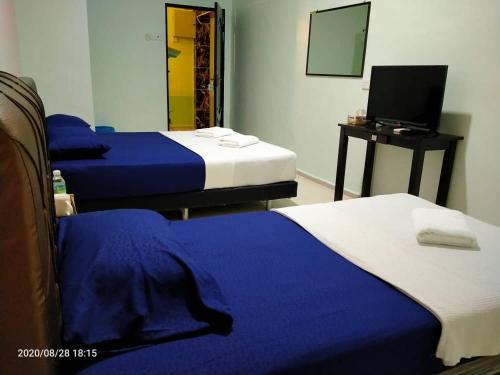 Krevet ili kreveti u jedinici u okviru objekta TAMIM SUITE GROUP HOTEL Dungun