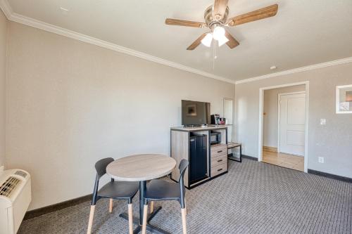 a dining room with a table and a ceiling fan at Harbor House Inn in Morro Bay