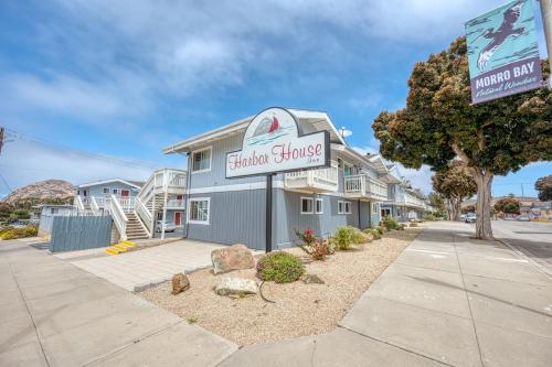 a building with a sign for a car dealership at Harbor House Inn in Morro Bay