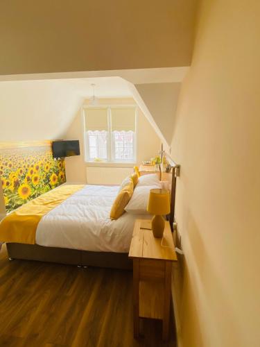 a bedroom with a large bed and a window at All Seasons Bed & Breakfast - Adults Only in Weston-super-Mare