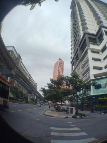 a city street with tall buildings and a street with cars at VUE RESIDENCE - 2 ROOMs in Kuala Lumpur