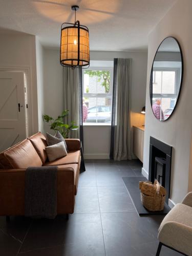 a living room with a couch and a fireplace at The Village House in Malahide