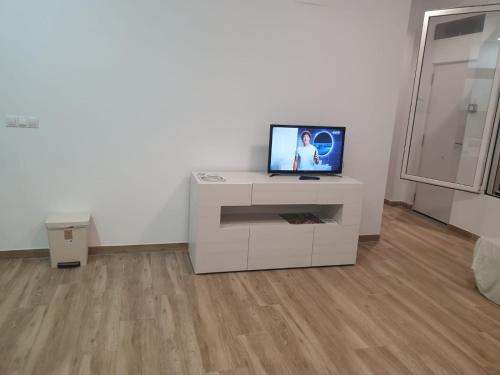 a living room with a television on a white cabinet at Premier Apartments in Valencia