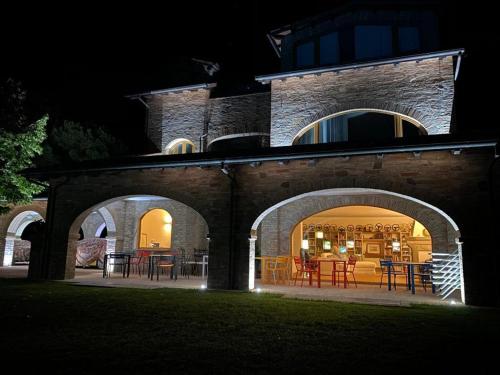 a house with an outdoor patio at night at Miataland in Collazzone