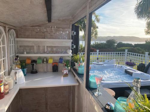 a jacuzzi tub sitting on top of a patio at Seaview Cottage on the Island in Millbay