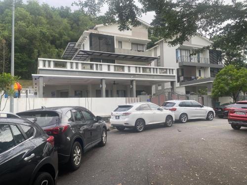 a group of cars parked in front of a building at 40PAX 7BR Villa with Kids Swimming pool, KTV, Pool Table n BBQ near SPICE Arena Penang 9800 SQFT in Bayan Lepas