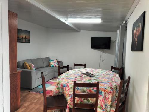 a living room with a table and a couch at Quintinha dos Reis in Funchal