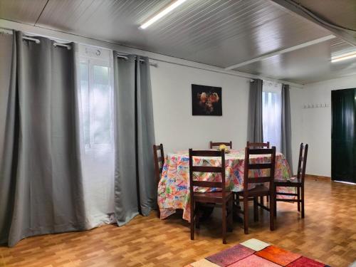 a dining room with a table and four chairs at Quintinha dos Reis in Funchal
