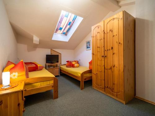 a bedroom with two beds and a skylight at Seeberger I in Strengen