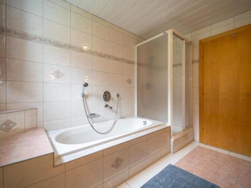 a bathroom with a bath tub and a shower at Seeberger II in Strengen