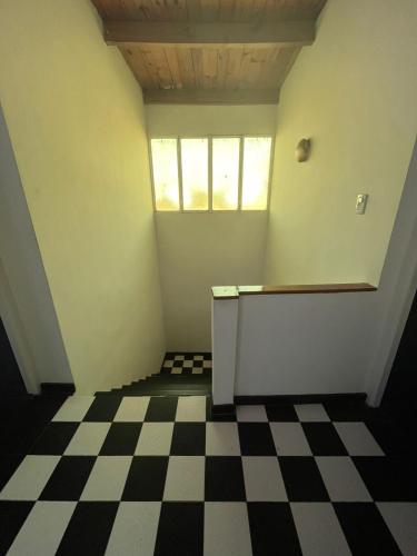 an empty room with a checkered floor at Casa Frente Parque Guillermina in San Miguel de Tucumán