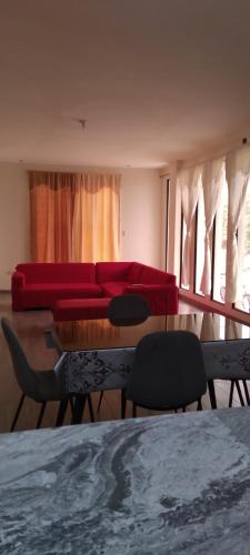 - un salon avec un canapé et des fauteuils rouges dans l'établissement Casa de Alexita, à Puerto Baquerizo Moreno