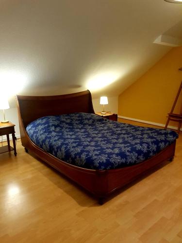 sypialnia z łóżkiem z niebieską kołdrą w obiekcie GEO 2 w mieście Horbourg