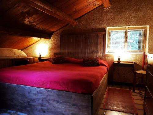 a bedroom with a large red bed in a room at Villaggio Barilari in Minucciano