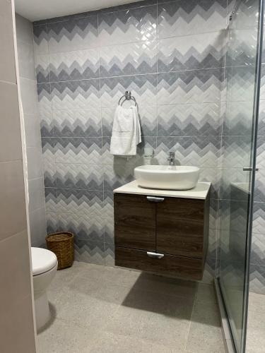 a bathroom with a sink and a shower at Hotel Taganga Plaza Santa Marta in Taganga