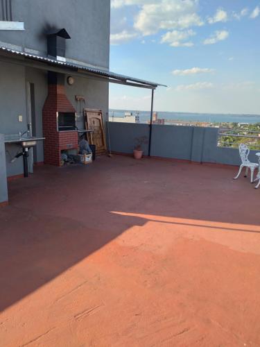a patio with a table and chairs on top of a building at Departamento Augusta in Posadas
