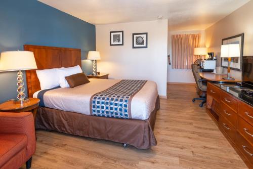 a hotel room with a bed and a desk at Riviera Inn in Port Angeles