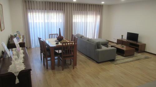 a living room with a couch and a table with a dining room at AL CASA DE SÃO ROQUE in Caminha