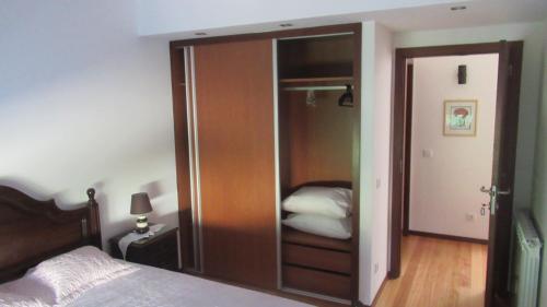 - une chambre avec un placard et un lit dans l'établissement AL CASA DE SÃO ROQUE, à Caminha