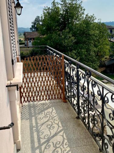 a balcony with a wrought iron railing and trees at Oasi di Monchiero in Monchiero