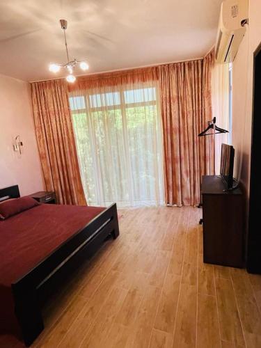 a bedroom with a bed and a large window at Villa Premium S in Bar