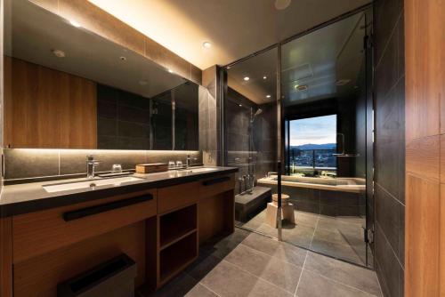 a bathroom with two sinks and a glass shower at Tokyu Stay Hida Takayama Musubinoyu in Takayama