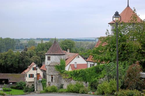 an old village with a street light and houses at AKZENT Hotel Am Bach in Dettelbach