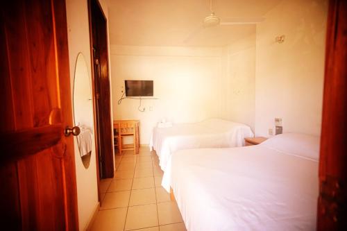 Postel nebo postele na pokoji v ubytování Hotel Yurimar