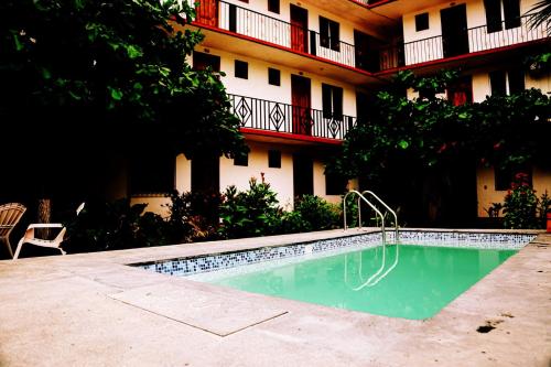 a swimming pool in front of a building at Hotel Yurimar in Puerto Escondido