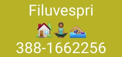 a sign with a woman sitting on a couch with a house at Filuvespri in Comiso