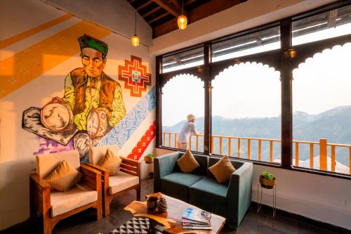 a living room with a mural on the wall at Zostel Banikhet (Dalhousie) in Dalhousie