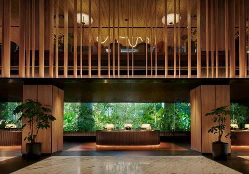 a lobby with a table and a chandelier at PARKROYAL COLLECTION Kuala Lumpur in Kuala Lumpur
