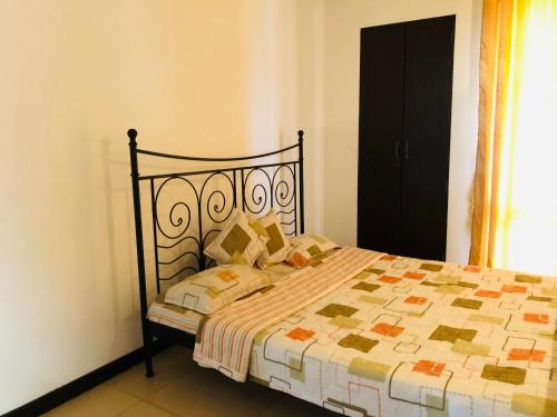 a bedroom with a bed with a quilt on it at Cinnamon Villa in Matara