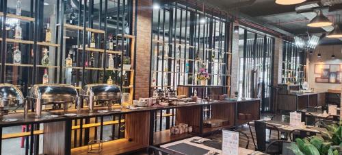 a barber shop with a lot of bottles on the wall at Rid's Hotel Palembang in Talang Kelapa