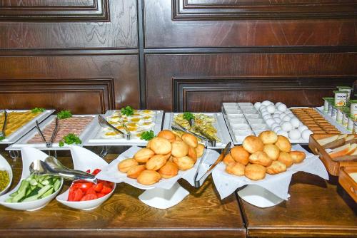a table topped with different types of food at Ramada by Wyndham Turkistan in Türkistan