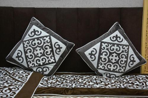two dice sitting on top of a bed at Ramada by Wyndham Turkistan in Türkistan