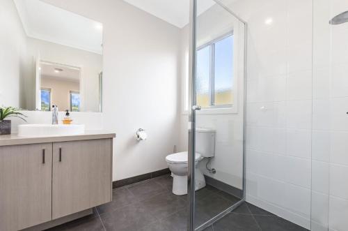 a bathroom with a toilet and a sink and a shower at Park View in Port Fairy