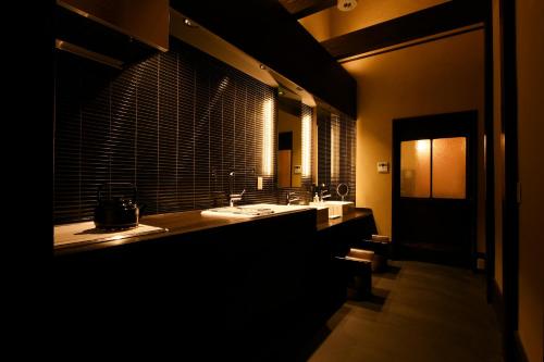 a bathroom with two sinks and a large window at Kuraya Omiya Shimabara in Kyoto