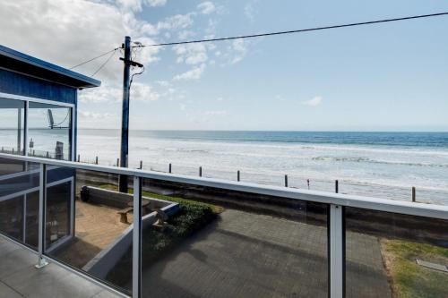 a view of the ocean from the balcony of a house at Sandy Cove in Port Fairy
